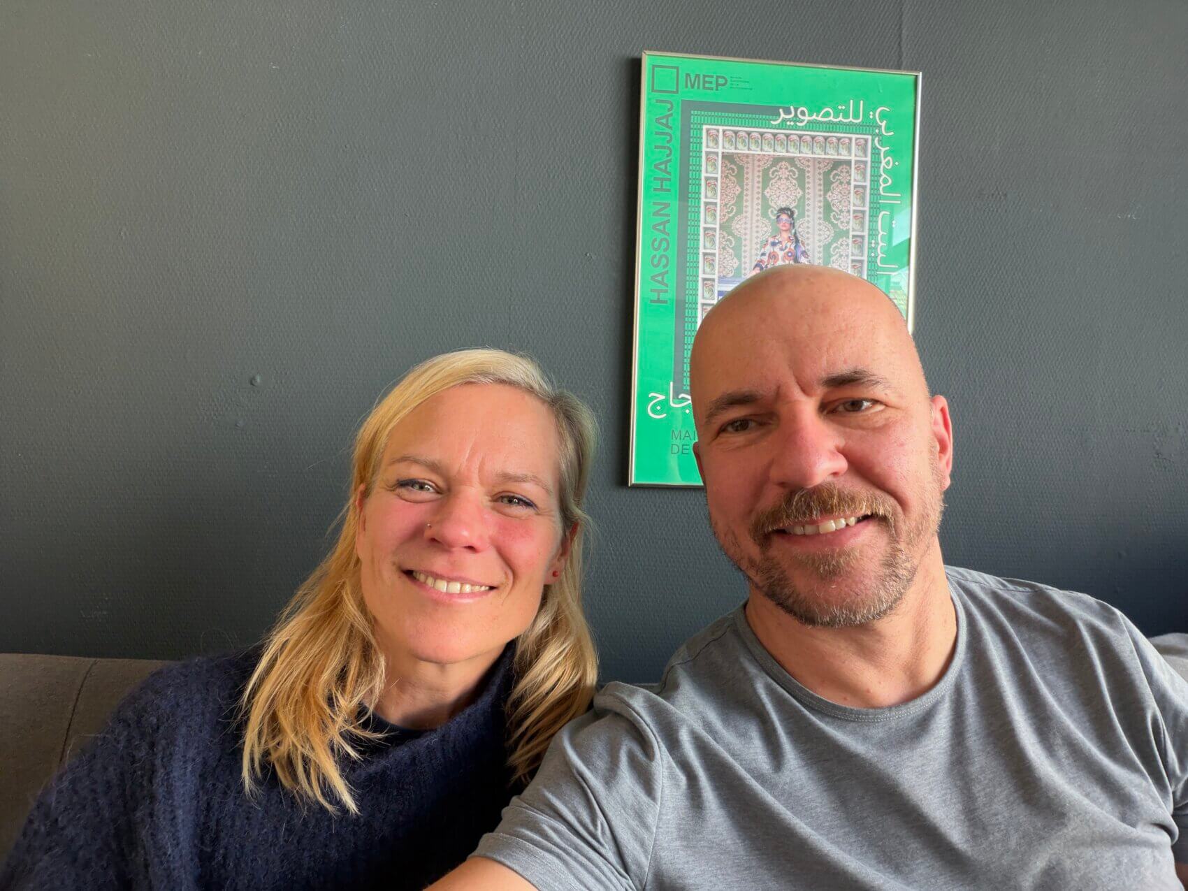 Selfie von zwei Personen vor grauem Hintergrund